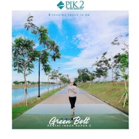 a woman is walking down a path with the words green belt