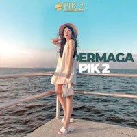 a woman in a white dress standing next to a body of water